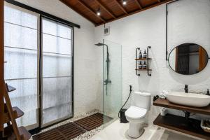 a bathroom with a sink and a toilet and a mirror at Exclusive New Villa in Ubud - 2BDR, Massive Pool - Ultimate Luxury in Ubud +8 photos