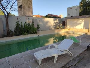 a swimming pool with a lounge chair and avisorvisor at The House you're looking for in Córdoba