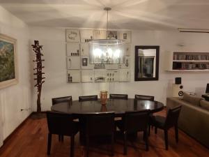 a dining room with a table and chairs and a couch at The House you're looking for in Córdoba
