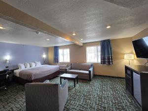 a hotel room with a bed and a flat screen tv at Quality Inn in Johnstown +61 photos