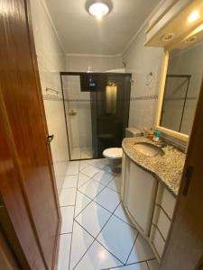 a bathroom with a toilet and a sink and a mirror at Imana Hostel in Florianópolis +45 photos