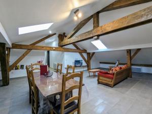 a living room with a table and a couch at Appartement cosy, 2 chambres et parking privé, proche des Vosges - FR-1-589-780 in Saint-Michel-sur-Meurthe +10 photos