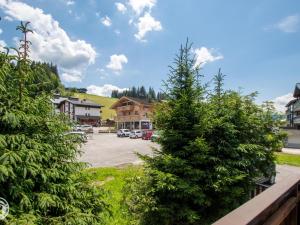 a christmas tree in front of a parking lot at Chalet cosy aux Gets avec parking privatif - FR-1-671-279 in Les Gets