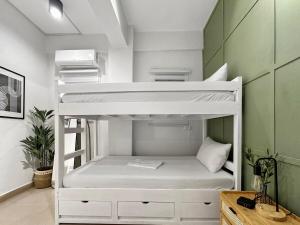 a room with two bunk beds in a room at Family Apartment By The Beach with Kitchen Netflix Station 3 Beachfront in Boracay