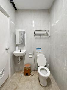 a bathroom with a toilet and a sink at Family Apartment By The Beach with Kitchen Netflix Station 3 Beachfront in Boracay