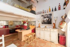 a large kitchen with a counter and a table at 2 Bedrooms central Saint-Tropez, next to the Port in Saint-Tropez