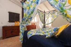 a bedroom with a canopy bed with blue and yellow curtains at 2 Bedrooms central Saint-Tropez, next to the Port in Saint-Tropez