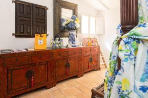 a bedroom with a dresser with a vase of flowers on it at 2 Bedrooms central Saint-Tropez, next to the Port in Saint-Tropez +20 photos