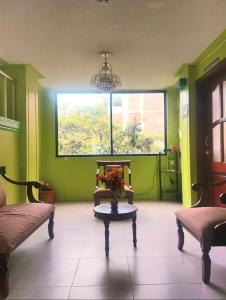 a living room with a vase of flowers on a table at Hotel Valle de Guano in Guano