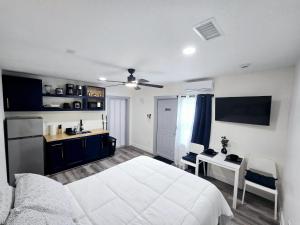 a bedroom with a white bed and a desk at Lovely Single Apartment in Tampa