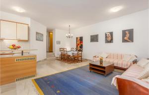 a living room with a couch and a table at Nice Apartment In Njivice With Wifi in Njivice