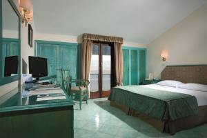 Posteľ alebo postele v izbe v ubytovaní Hotel Iaccarino