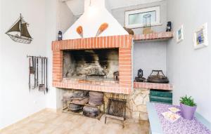 a brick fireplace in a living room with at Two-Bedroom Apartment In Ratac in Orasac