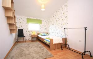 a bedroom with a bed and a desk and a window at Holiday Home Drinovci With A Fireplace 444 in Drinovci