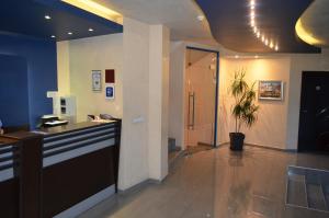 a lobby with a counter and a potted plant at Riverside Family Hotel in Yambol