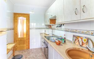 a kitchen with a sink and a counter top at Awesome Apartment In Santa Pola in Santa Pola