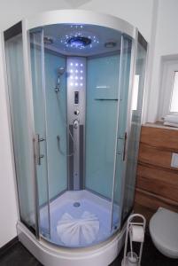 a shower with a glass enclosure in a bathroom at Petul Apart Hotel Am Ruhrbogen in Bochum