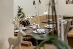 a wooden table with plates and napkins on it at Haus Amaris in Sölden