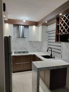a kitchen with a sink and a stove top oven at Casa palmar sercas del Nilo in Mexico City