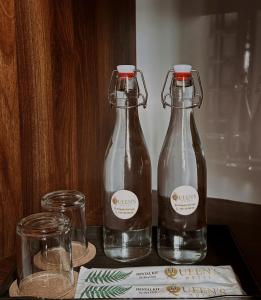 two bottles of water and two glasses on a table at Queen's Motel Huế in Thôn Lại Thê +17 photos