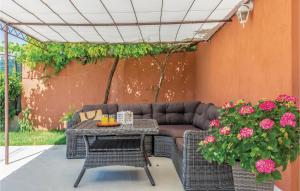 a patio with a couch and tables and flowers at Holiday Home Kresevo 23 in Kreševo