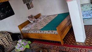a bedroom with a bed with a wooden frame at Karma Dreamland homestay in Rongli