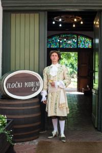 a woman standing in front of a building at Hotel Stari Podrum in Ilok