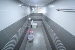 a small bathroom with a toilet and a sink at Aarna Coastal Resort in Māvalli +35 photos