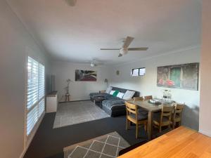 a living room with a couch and a table at Sorrento Haiven in Perth
