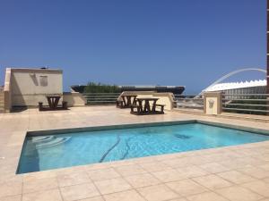 a swimming pool on top of a building at Grange Gardens Hotel in Durban