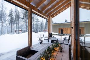 a screened in porch in the snow with a fireplace at Santa's Royal Resort in Rovaniemi