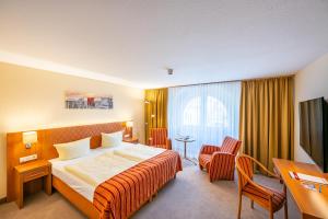 Postel nebo postele na pokoji v ubytování Centralhotel Binz
