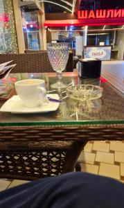a glass table with a cup and aucer on it at Luxury Living in Kabul in Kabul