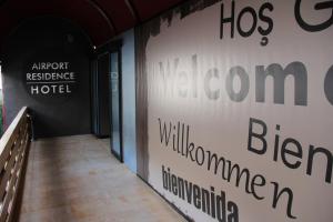 a hallway in a building with a sign on the wall at Airport Residence in Istanbul