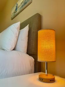 a lamp sitting on a table next to a bed at Park View in Cherry Hinton +21 photos