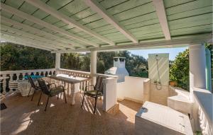 a pergola with a table and chairs on a deck at Awesome Home In Nevidane With Wifi in Neviđane