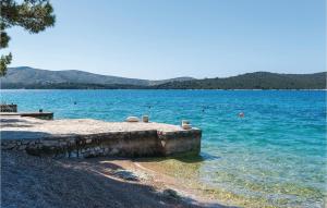 a large body of water with people swimming in it at Three-Bedroom Holiday Home In Zaboric in Zaboric
