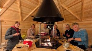 a group of people sitting around a table in a cabin at Hotel Bergsonne Rigi Kaltbad in Rigi Kaltbad