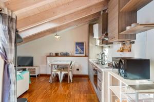 a kitchen with a table and a dining room at Loft&Sun in La Spezia +34 photos