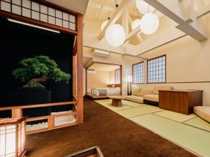 a living room with a tree mural on the wall at KONJAKUSO Osaka Tempozan KANOH SHOHAKU Sakura Pine Tree in Osaka