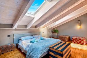 a bedroom with a large bed and a skylight at Loft&Sun in La Spezia