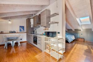 a kitchen with a counter and a table in a room at Loft&Sun in La Spezia