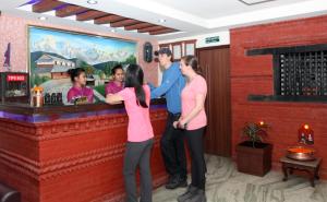 a group of people standing at a bar at Alpine Hotel & Apartment in Kathmandu