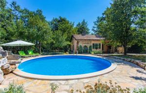 a swimming pool in the backyard of a house at Gorgeous Home In Pazin With Kitchen in Pazin +24 photos