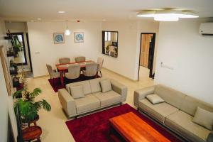a living room with a couch and a table at Elles Residence - Serenity in Dar es Salaam