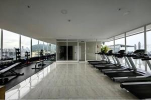 a gym with a row of treadmills and machines at 80M Luxury Ocean View Apartment PH The Sands, Next to Hilton in Panama City