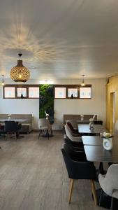 a living room with tables and chairs and a dining room at Europa Ocna Mures in Ocna-Mureşului +36 photos