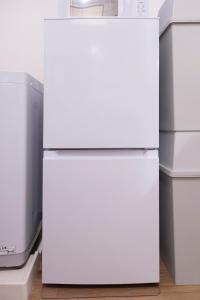 Nishi-hiranumachōにあるSakura Yoshinochou Residenceの2台の白い冷蔵庫が隣り合って置かれている