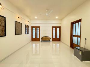 a large white room with a bench on the wall at Soul Route in Bhubaneshwar
