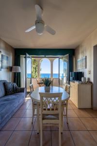 a living room with a table and a couch at Baba Residences in Alassio